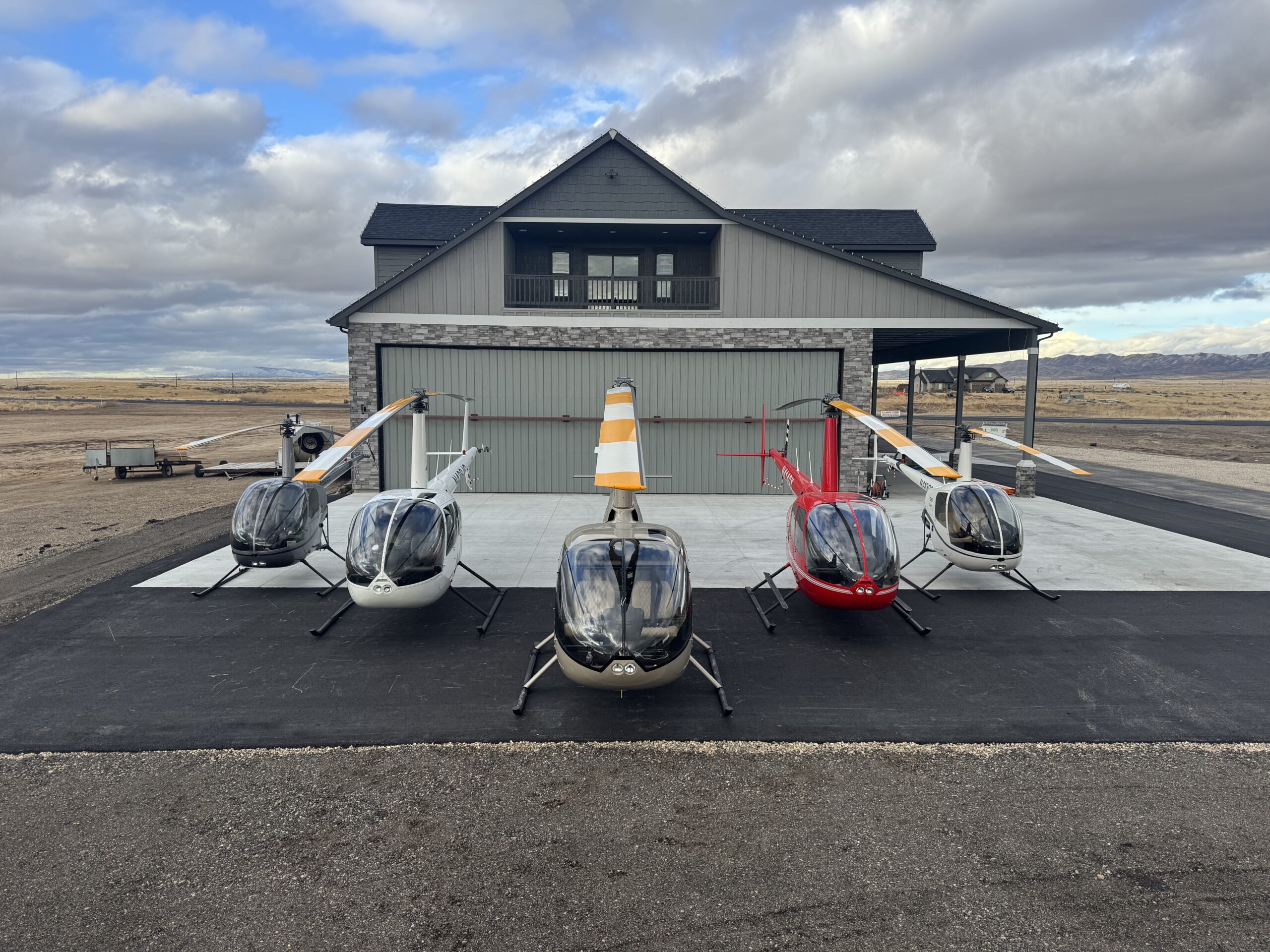 Campus hangar with helicopters parked outside